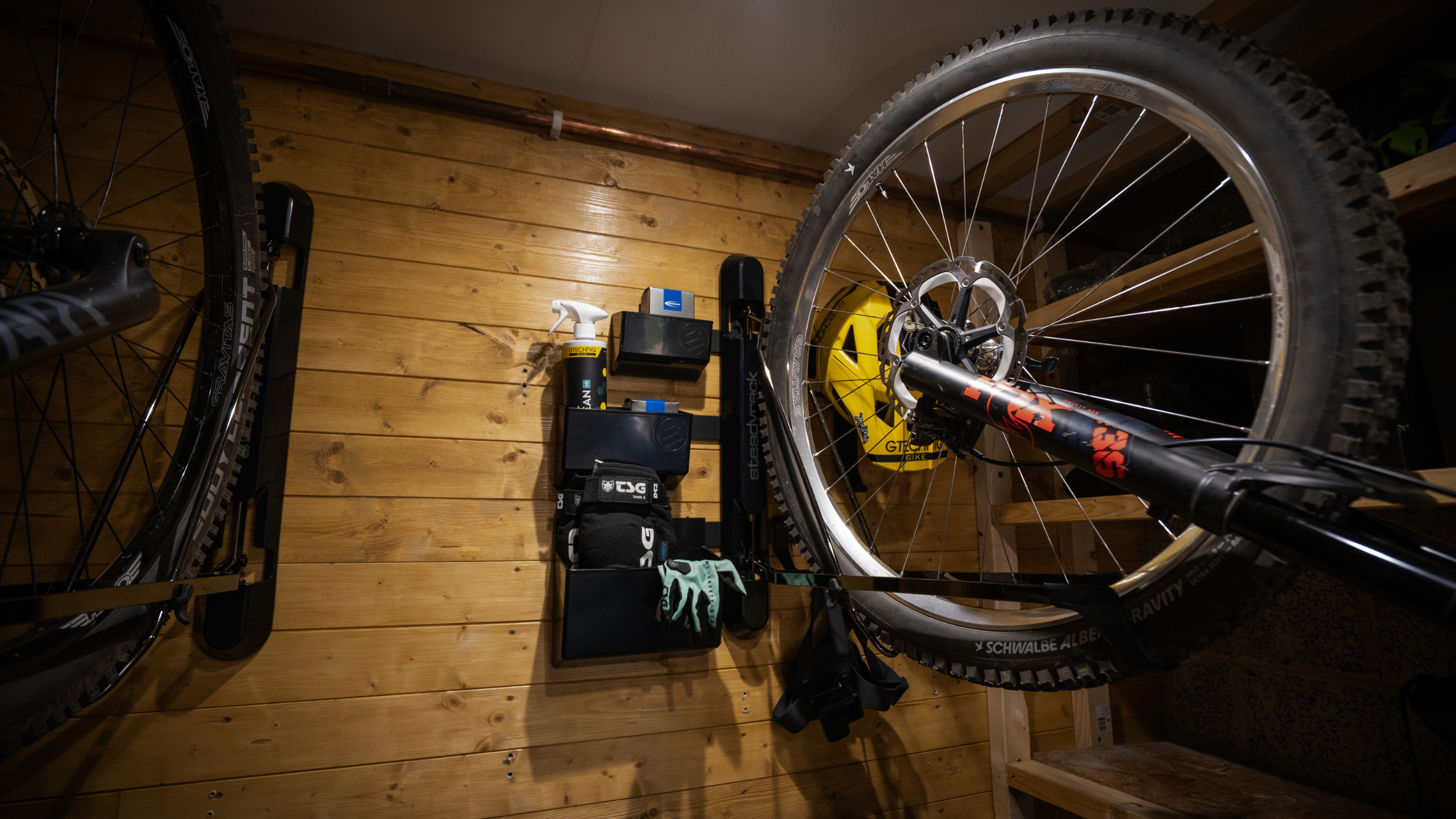 Bicycle on a stand in a workshop with tools and equipment.